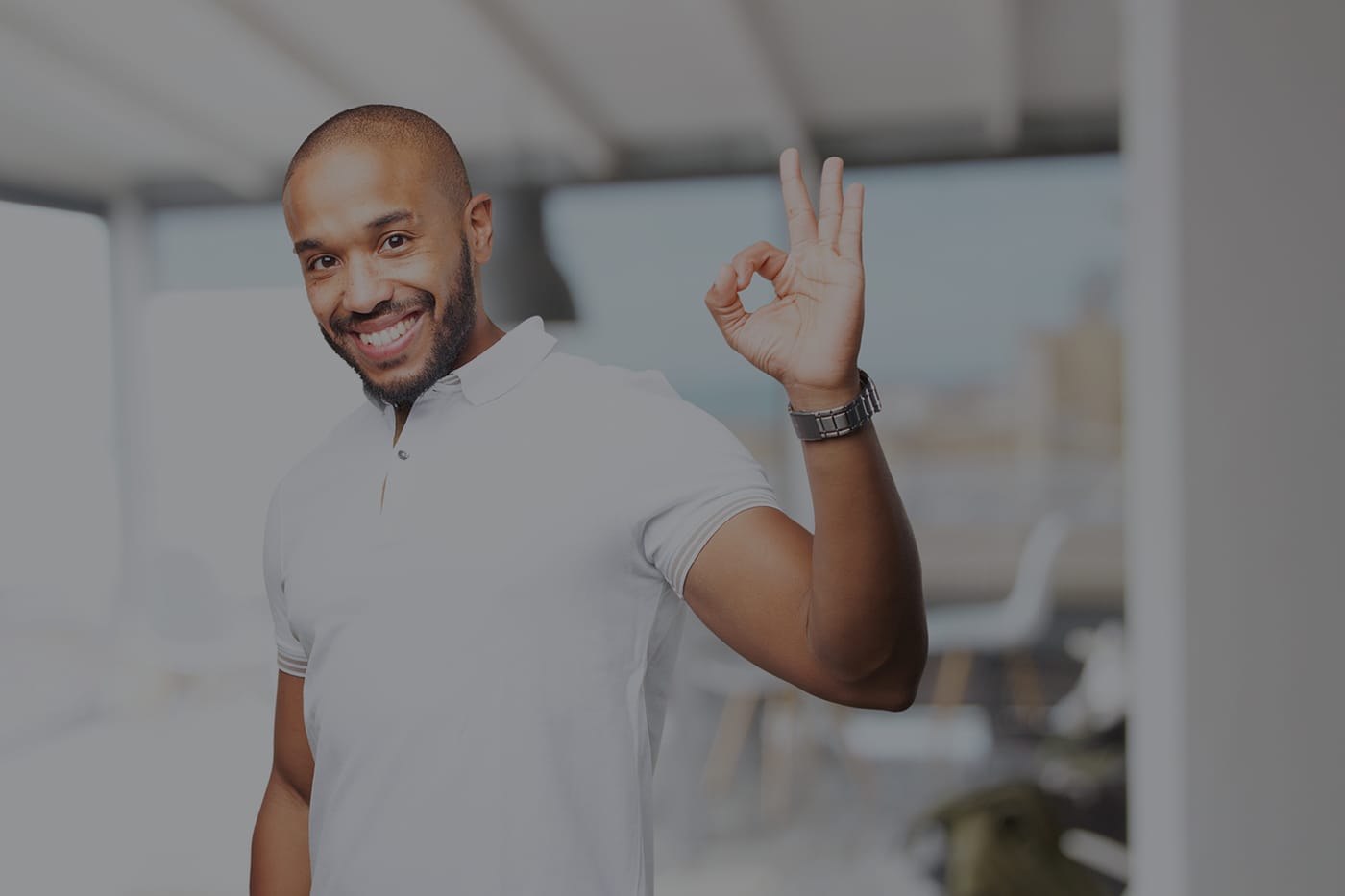 Smiling man giving an OK sign